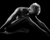 Naked fitness blonde woman expressing sexy joy in blakc and white.