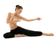 Naked Fit Club member on the beach doing yoga.
